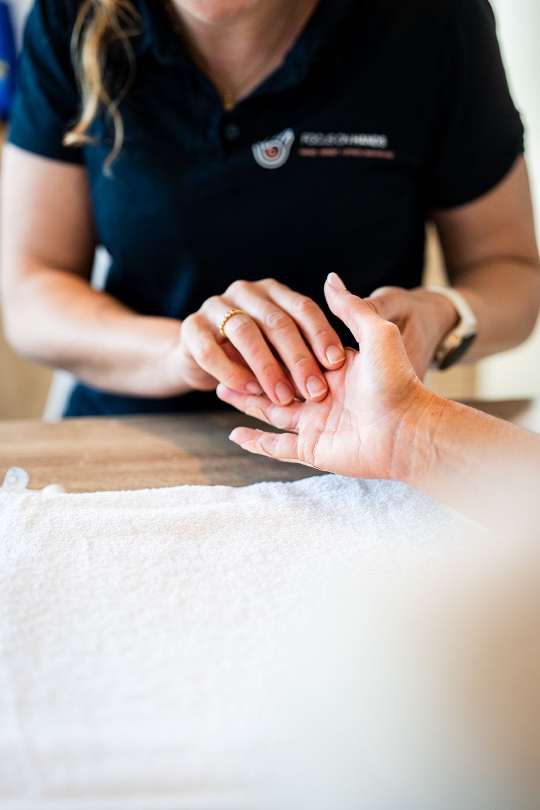 Danielle Crestani supporting a patient's hand during treatment