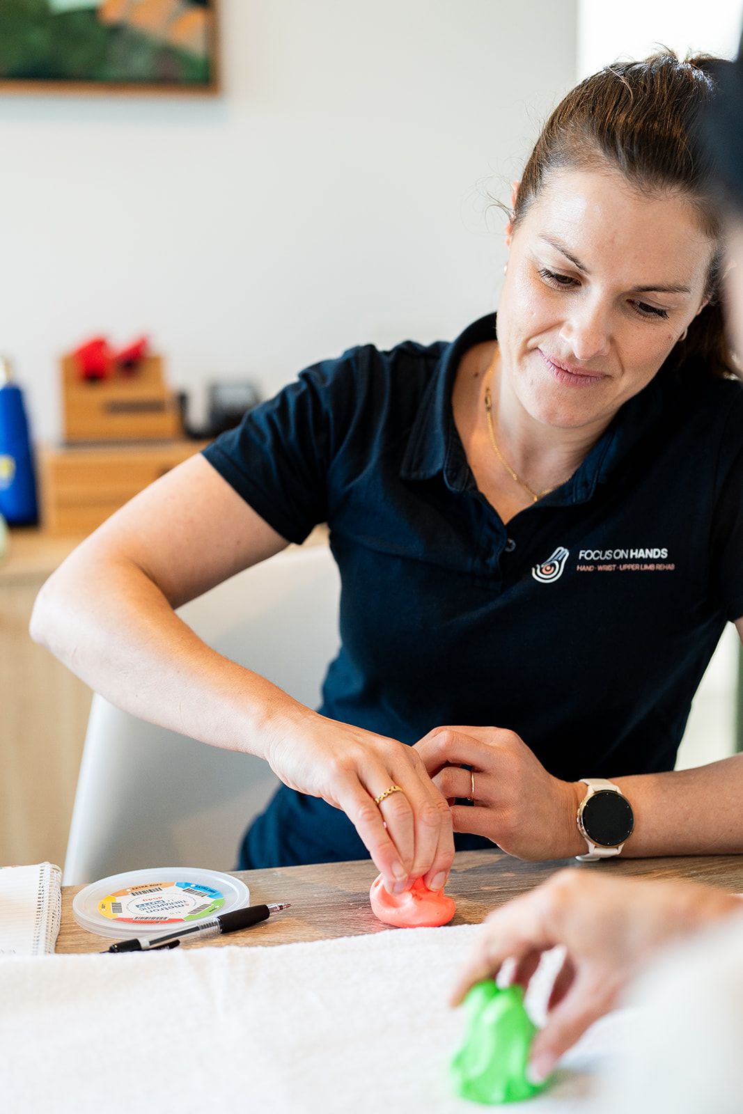 Danielle Crestani demonstrating a therapy putty exercise
