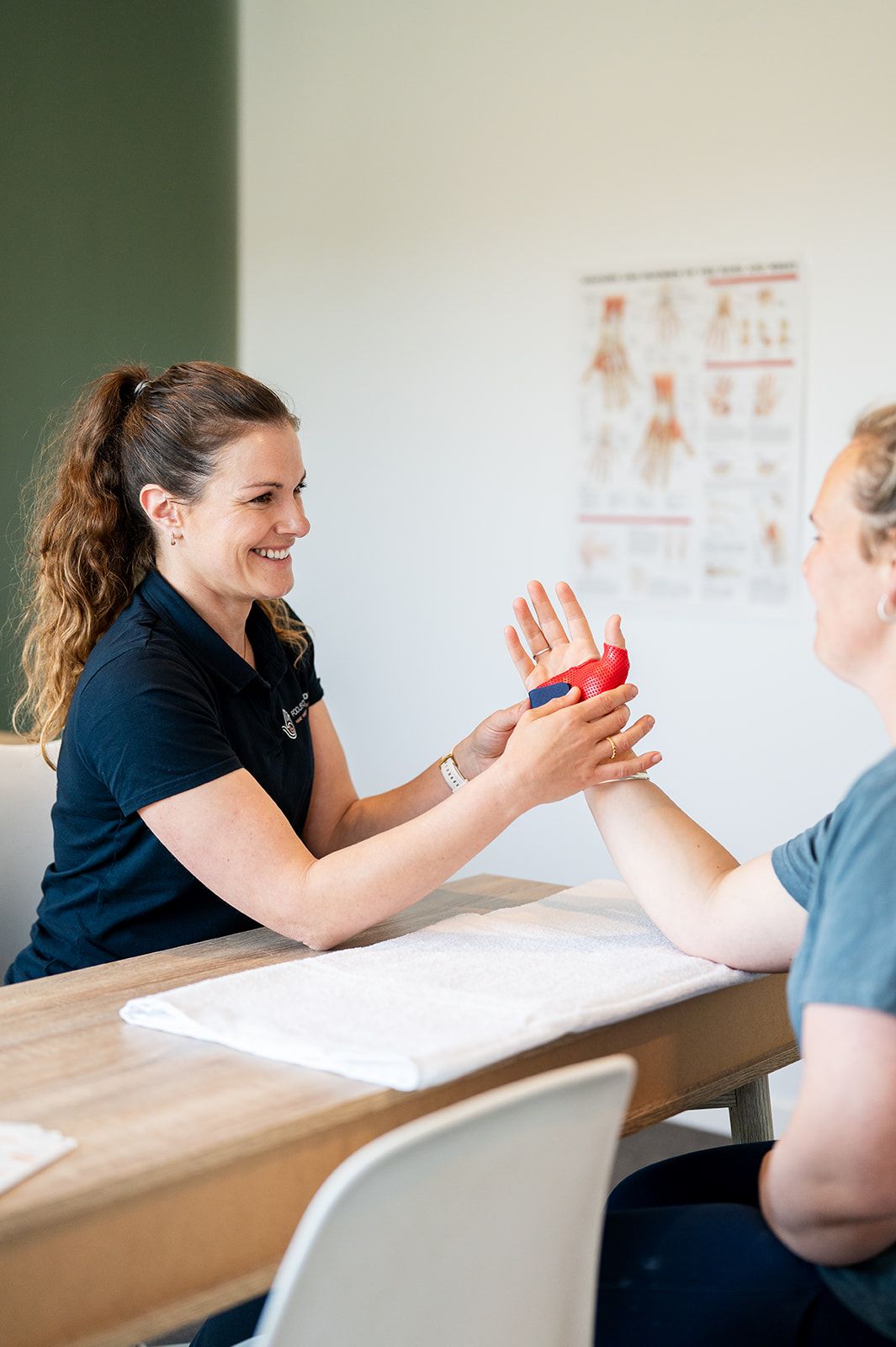 Danielle Crestani smiling with a patient during a session